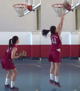 Foto de baloncesto de una niña realizando un tiro de fuerza, saltando hacia el tablero